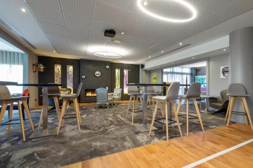 a meeting room with tables and chairs in an office at Pullman Toulouse in Blagnac