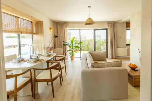 a living room with a couch and a table at Huswell - Modern Apartment with Garden, Near Beach in Cadzand