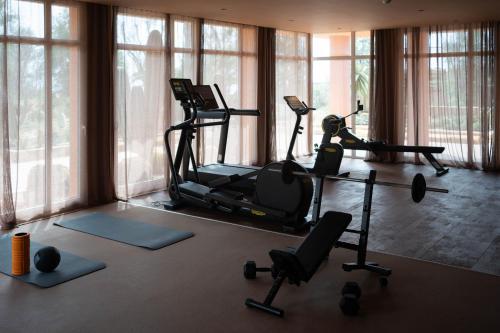 a gym with several exercise bikes in a room with windows at Bikini Island & Mountain Hotel Es Trenc -Adults only- in Colonia Sant Jordi