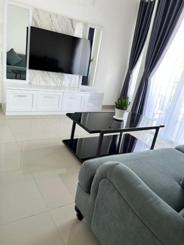 a living room with a couch and a tv at The Villas in Bogor