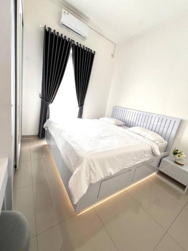 a bedroom with a large bed with a window at The Villas in Bogor