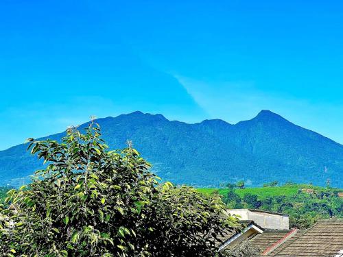 a view of a mountain with a rainbow in the sky at The Villas in Bogor