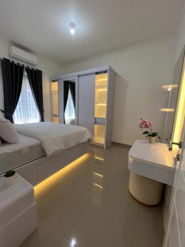 a bedroom with a large bed with a light on the floor at The Villas in Bogor