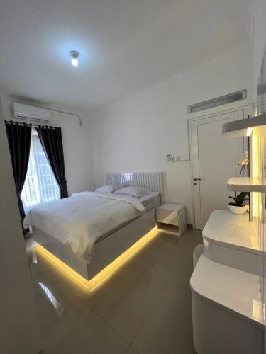 a bedroom with a bed with a light on it at The Villas in Bogor