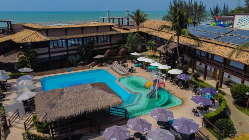 an aerial view of a resort with a swimming pool at Hotel Vilarejo Praia in Rio das Ostras