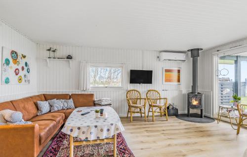 a living room with a couch and a table at 3 Bedroom Lovely Home In Bjert in Binderup Strand
