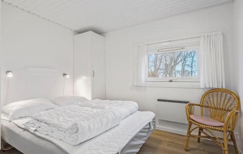 a white bedroom with a bed and a chair at 3 Bedroom Lovely Home In Bjert in Binderup Strand