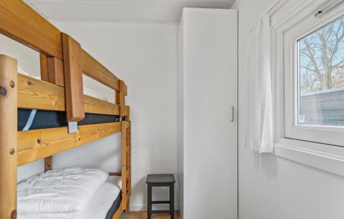 a bunk bed in a room with a window at 3 Bedroom Lovely Home In Bjert in Binderup Strand
