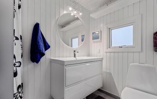 a white bathroom with a sink and a mirror at 3 Bedroom Lovely Home In Bjert in Binderup Strand