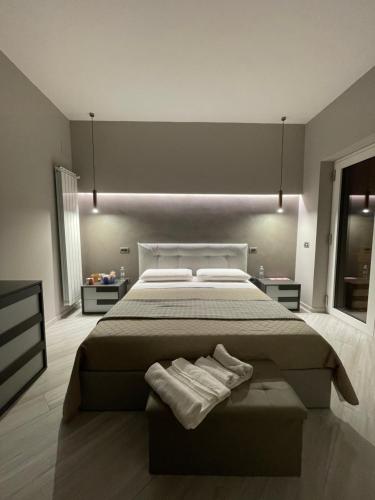 a bedroom with a large bed with two towels on it at La quercia in Ticchiena