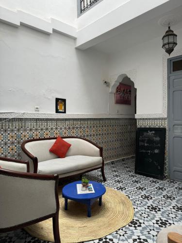 a living room with a couch and a table at RIAD DAR LFONOUN in Marrakech