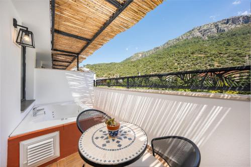 a table and chairs on a balcony with a view at Ölüdeniz Blu Luxury Unique Hotel - Adults-Only in Oludeniz