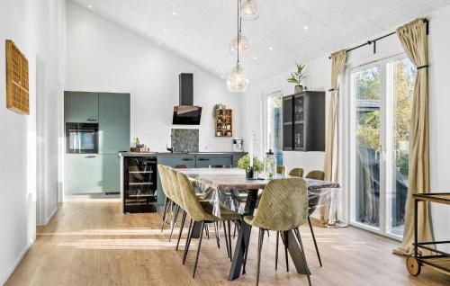 a kitchen and dining room with a table and chairs at Lovely Home In Skjern With Wifi in Skjern