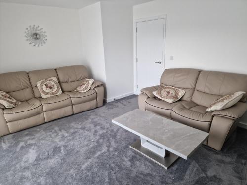 a living room with a couch and a coffee table at Stratford Way House in Northfleet