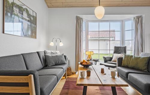 a living room with a couch and a table at 4 Bedroom Nice Home In Gråsten in Gråsten