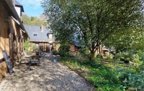 a backyard of a house with a tree and chairs at 1 Bedroom Nice Apartment In Montville in Montville