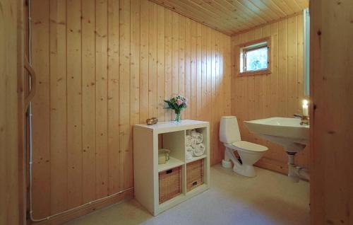 a bathroom with a toilet and a sink at Gorgeous Home In Likenäs With Sauna in Likenäs
