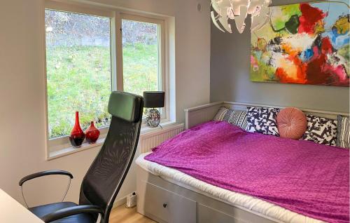a bedroom with a bed with a pink blanket on it at 2 Bedroom Cozy Home In Huskvarna in Huskvarna