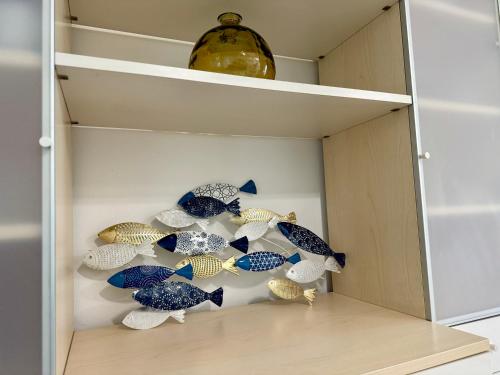 a cabinet filled with blue and white glass umbrellas at Villa Azzurro Blu in Lignano Sabbiadoro