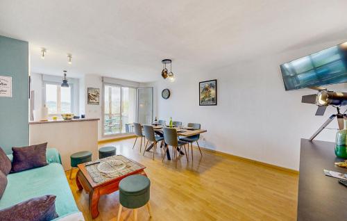 a living room with a couch and a table and chairs at Pet Friendly Apartment in Bagnères-de-Bigorre