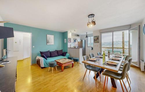 a living room with a table and a couch at Pet Friendly Apartment in Bagnères-de-Bigorre