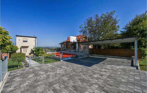 an open patio with a fence and a building at Awesome Home In Radovan With Sauna in Lovrečan Podbelski