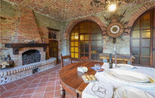 a living room with a fireplace and a wooden table at Nice Apartment In Santo Stefano Belbo in Santo Stefano Belbo