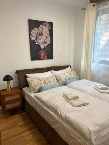 a bedroom with a large bed with white sheets at Zlatiborske terase Spa&Wellness in Zlatibor