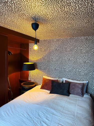 a bedroom with a white bed and a ceiling at Cosy Boudoir Suites - 4p in Antwerp