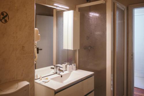 a bathroom with a sink and a toilet and a mirror at App Panoramico 300 mt dalle Piste Relax e Vista Alpi in Passo del Tonale