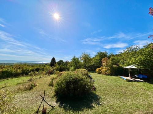 a view of a yard with a gazebo at Ugra Miradore Balatonalmadi in Balatonalmádi