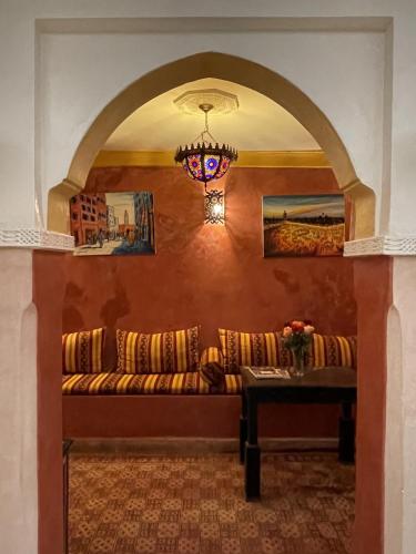 a living room with a couch and a table at Riad Mboja Chez Ali Baba in Marrakesh