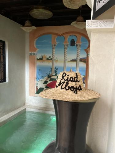 a hat sitting on top of a pool at a resort at Riad Mboja Chez Ali Baba in Marrakesh