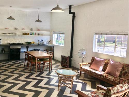 a living room with a couch and a table at The Old Mushroom Farm in Howick