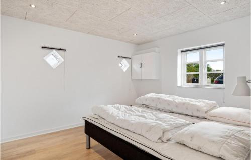 a bedroom with white walls and a large bed at Lovely Home In Tim With Sauna in Halkær