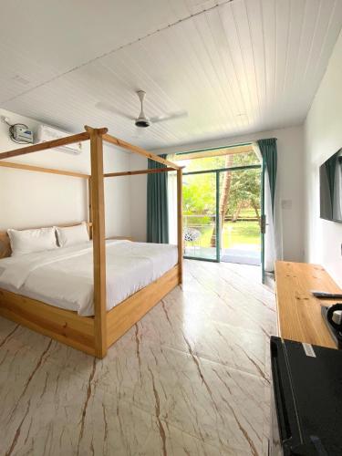 a bedroom with a bed and a desk at Magic Sand Beach Resort in Arambol
