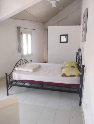 a bedroom with a bed in a white room at Zion in Ngaparou