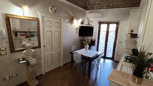 a living room with a table and a mirror at A Casa di Mamma Rita in Chieti
