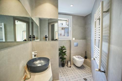 a bathroom with a sink and a toilet at Dream Luxury Apartment in the City Center by BiNoBi! in Thessaloniki