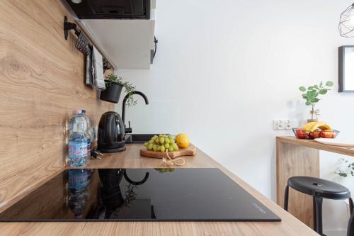 a kitchen with a counter with a laptop on it at Apartamenty Silver Place in Szczecin