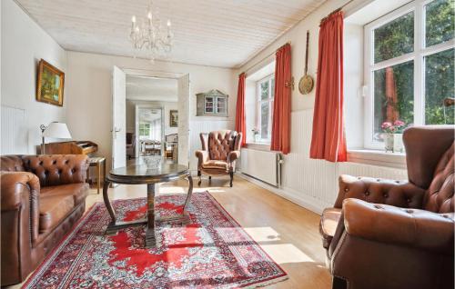 a living room with a table and chairs at Foldingbro Kro in Lintrup