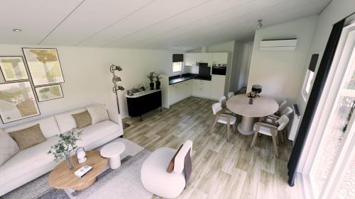 a living room with a couch and a table at Camping de Vogel in Hengstdijk