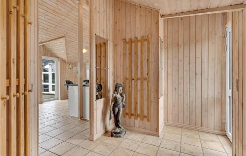 a hallway with a statue in the middle of a room at Gorgeous Home In Ringkøbing With Sauna in Søndervig
