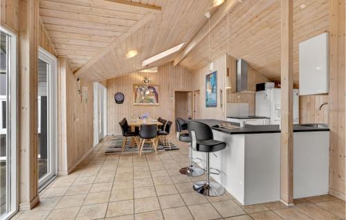 a kitchen and dining room with a table and chairs at Gorgeous Home In Ringkøbing With Sauna in Søndervig