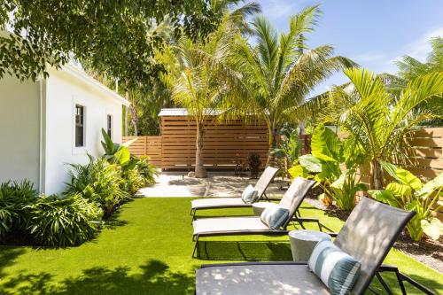 a yard with lawn chairs and palm trees at La Siesta Resort & Villas in Islamorada