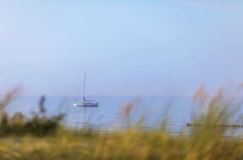 a sail boat in the middle of the water at Boddenluemmel in der Seefahrtschule in Wustrow
