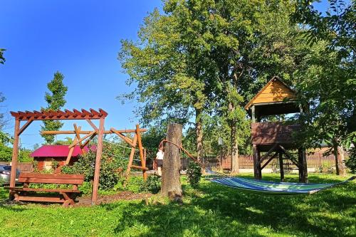 a hammock and a gazebo and a playground at Chata pod Mogielicą komfortowe pokoje z widokiem na Mogielicę 1000m od tras wokół góry Mogielica in Słopnice
