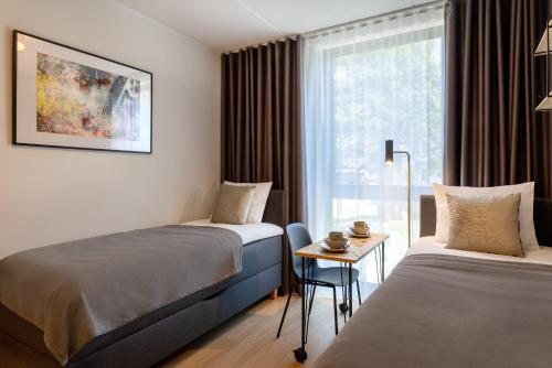Postel nebo postele na pokoji v ubytování Hessnery Hotel