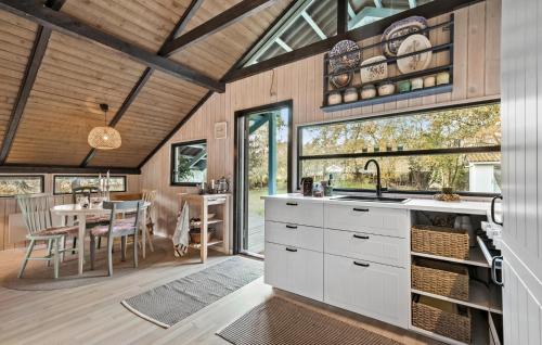 a kitchen and dining room with a sink and a table at Stunning Home In Rønde With Wifi in Rønde