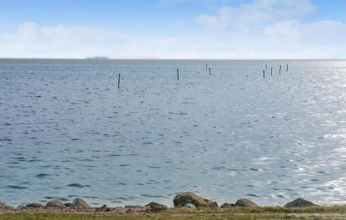 a large body of water with poles in the water at 3 Bedroom Awesome Home In Dannemare in Dannemare